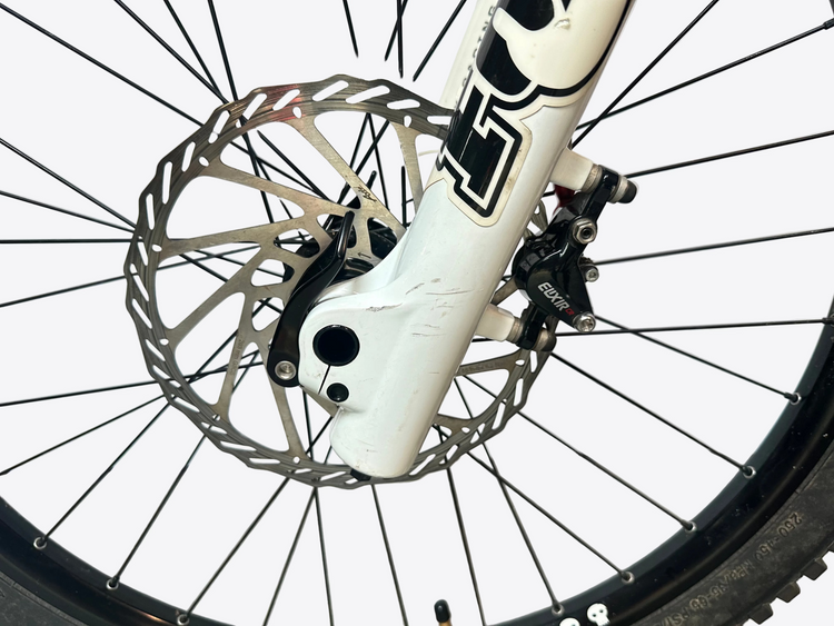 Close-up of a bicycle wheel with disc brake system on a white background