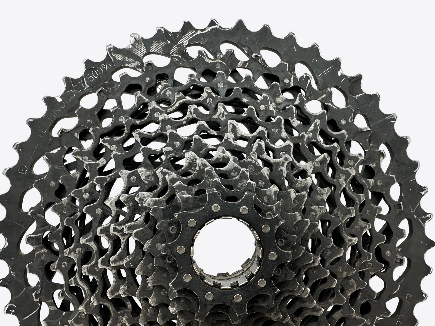 Close-up of a bicycle gear cassette on a white background