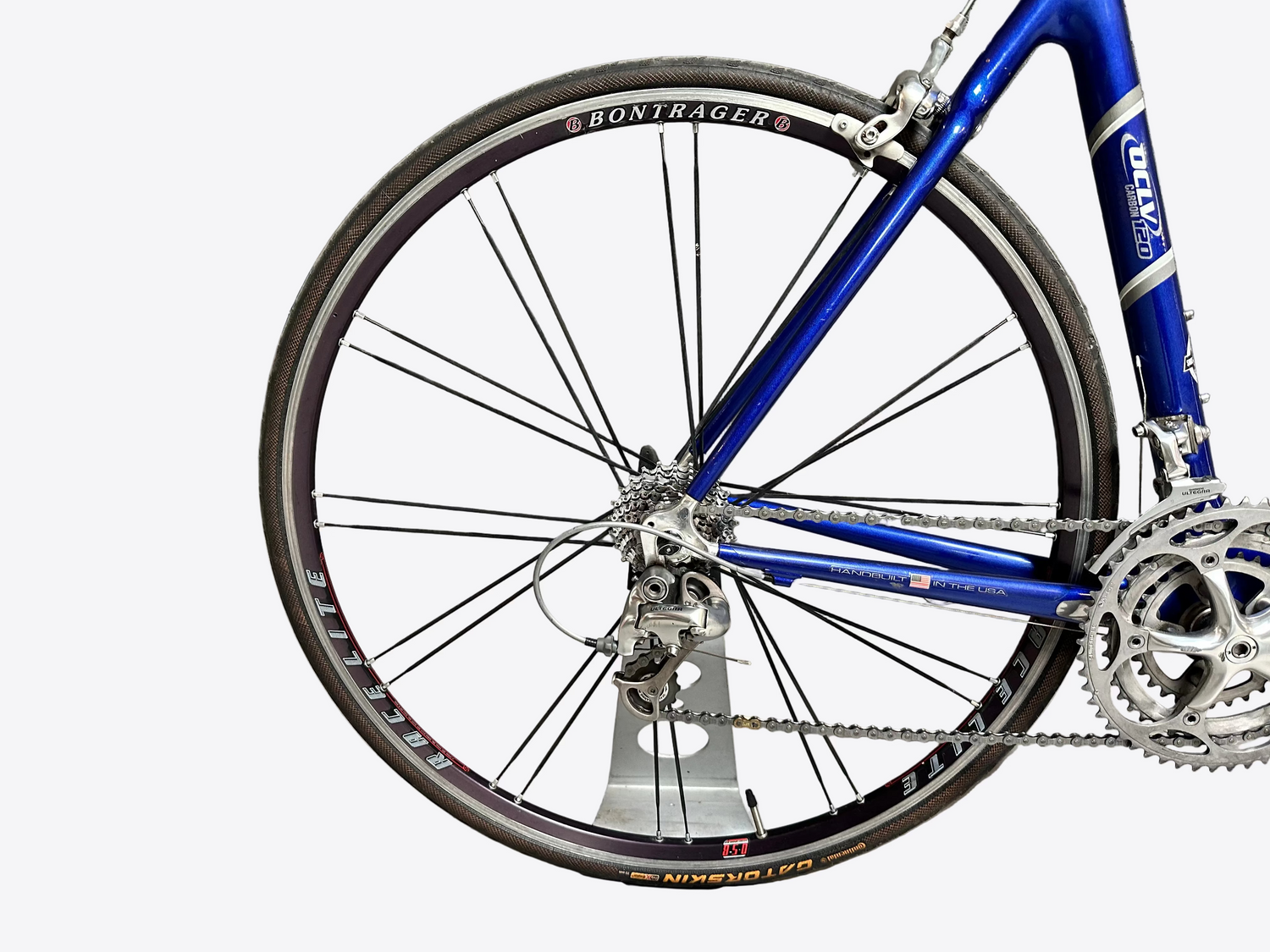 Blue bicycle with Bontrager components against a gray brick wall.