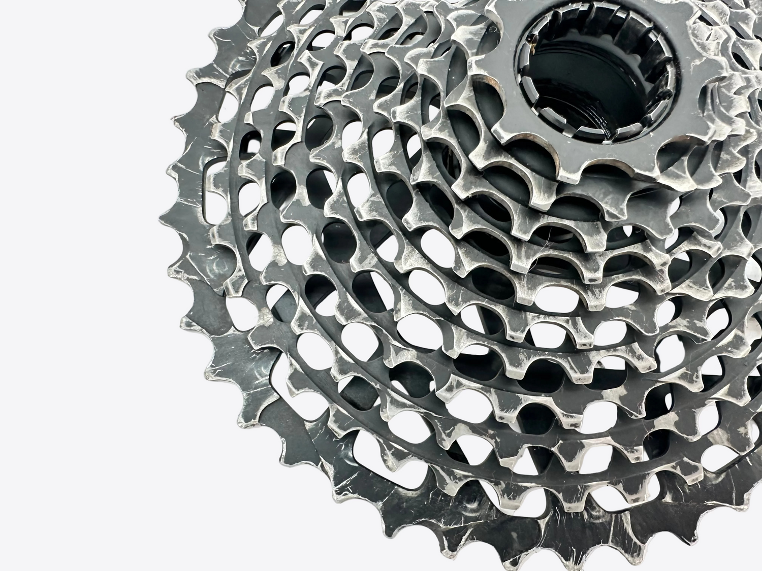 Close-up of a bicycle gear cassette on a white background