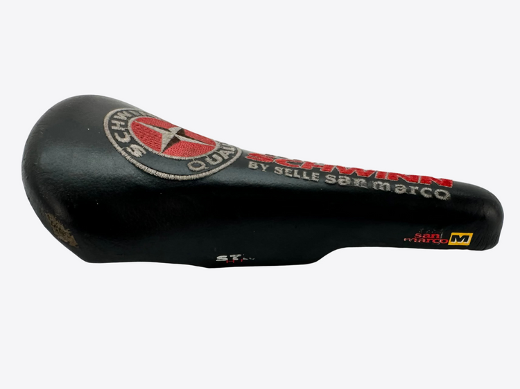 Black bicycle seat with branding on a white background
