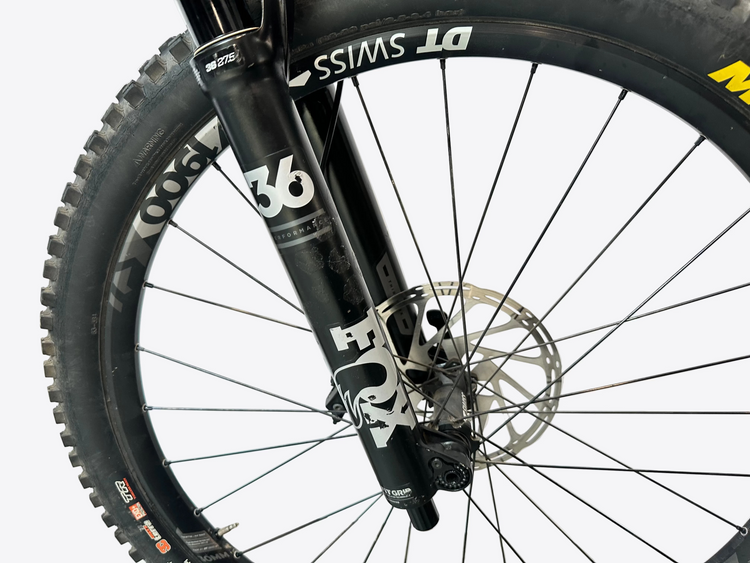 Close-up of a bicycle wheel with visible brand names on the fork and rim.