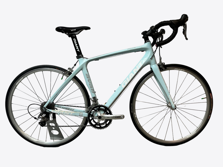 Light blue bicycle on a gray floor with a white wall background