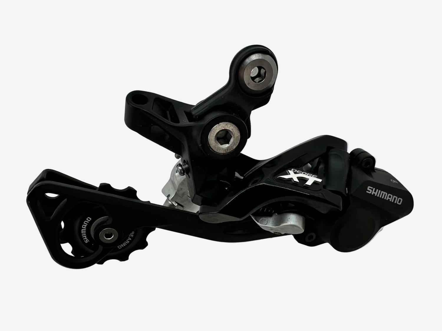 Black Shimano XT mechanical component on a white background