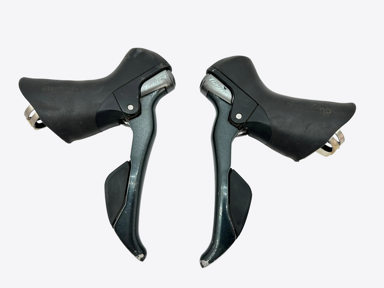 Pair of black bicycle shifters on a white background