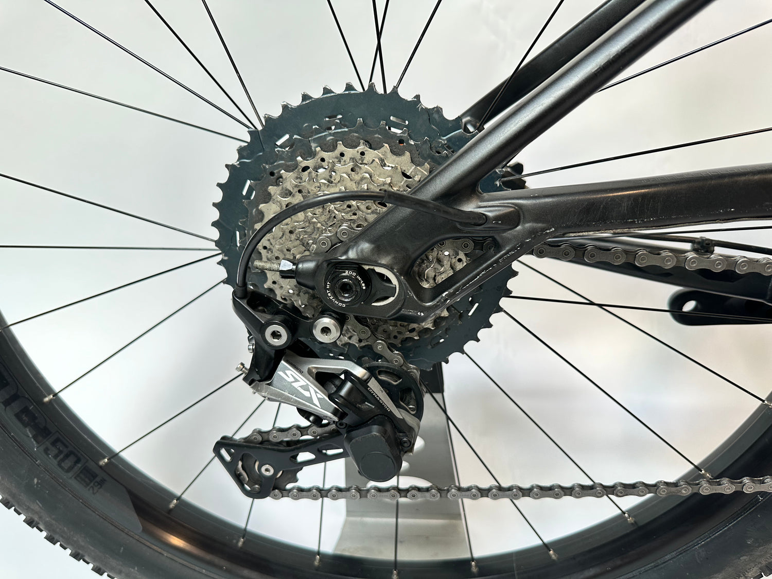 Close-up of a bicycle's gear system with chain and sprockets on a white background