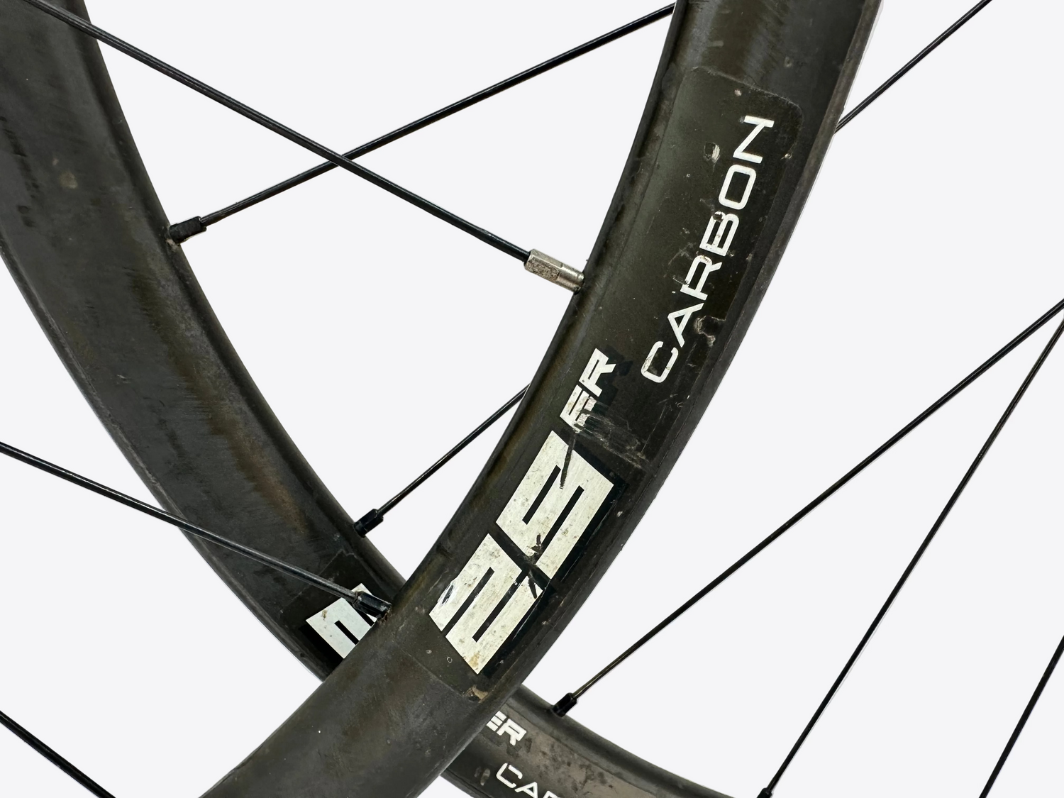 Close-up of a bicycle wheel with 'Carbon' and '29er' branding on a blurred background