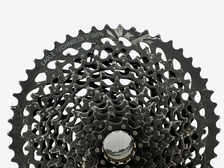 Close-up of a bicycle gear cassette on a white background
