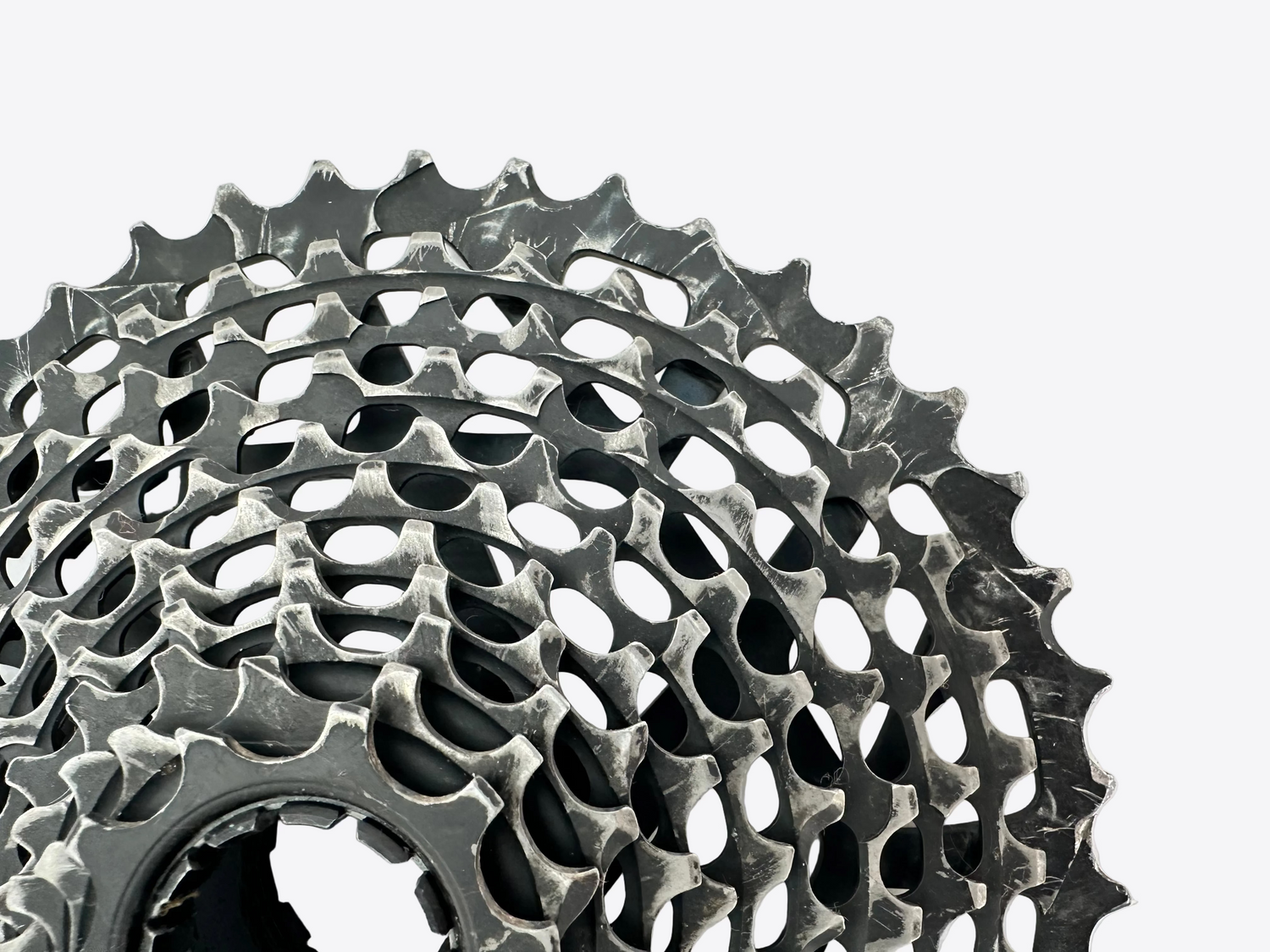 Close-up of a bicycle gear cassette on a light gray background