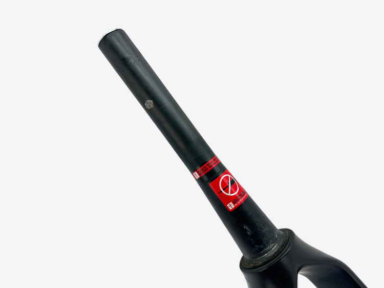 Black bicycle fork with a red label on a white background