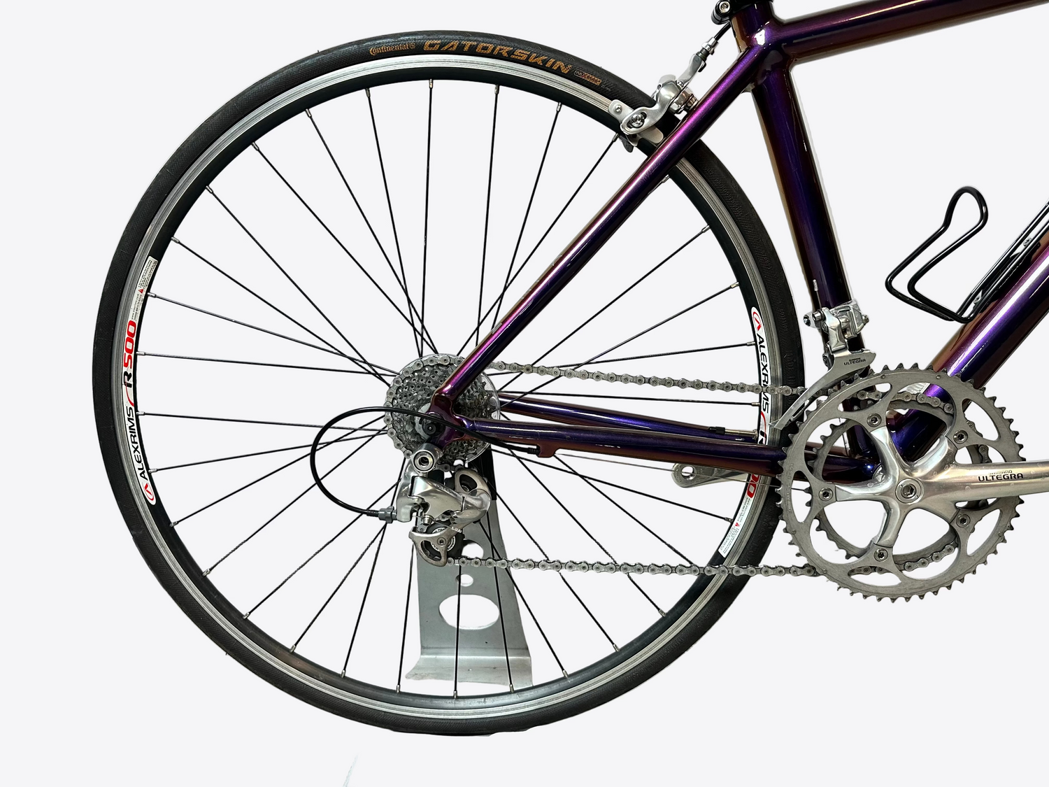 Close-up of a bicycle wheel and chain on a white background