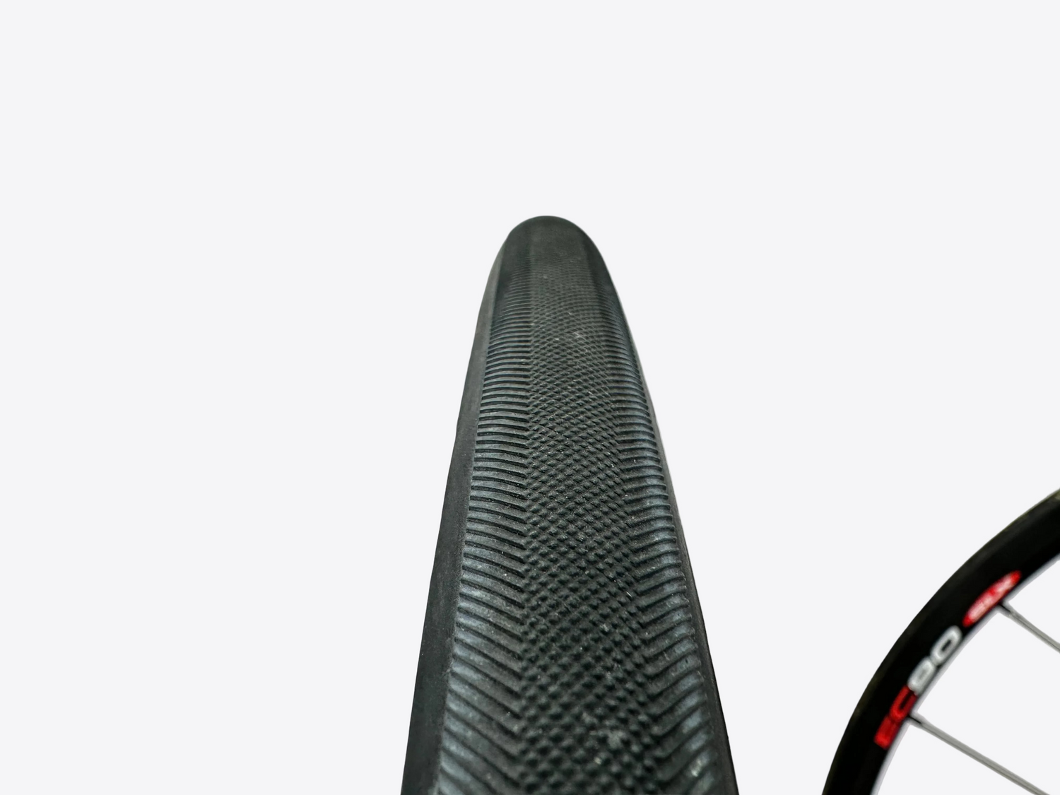 Close-up of a bicycle tire with tread pattern on a white background