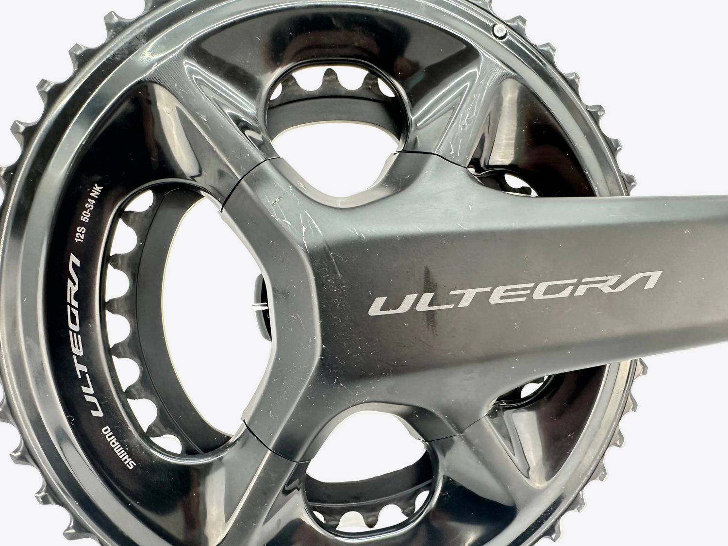 Close-up of a bicycle crankset with 'Ultegra' branding on a white background