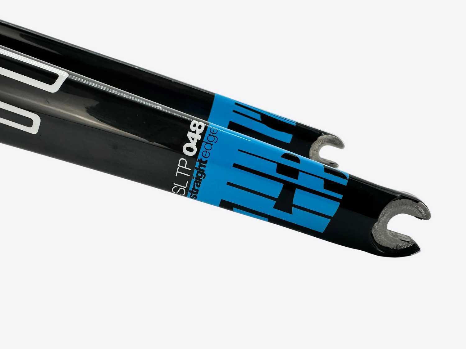 Close-up of a black bicycle fork with blue and white branding on a white background