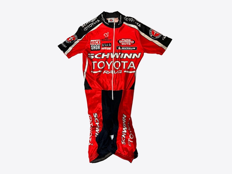 Red and black cycling suit with various brand logos on a white background