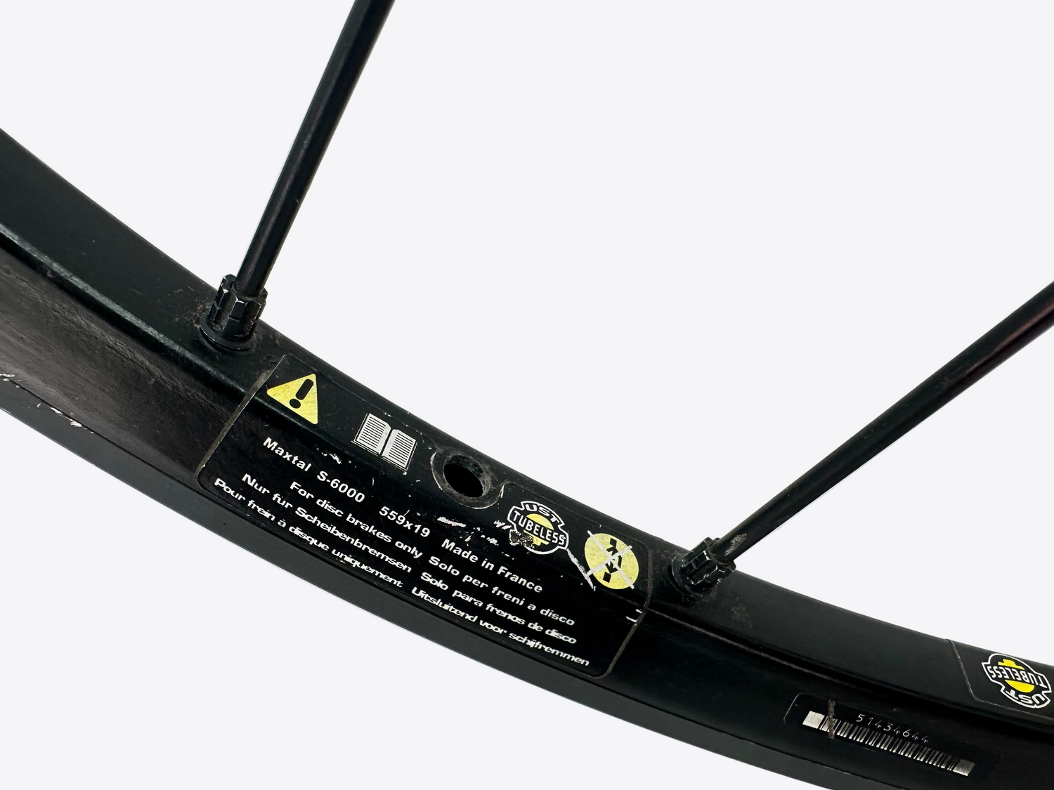 Close-up of a bicycle wheel with branding and specifications on a white background