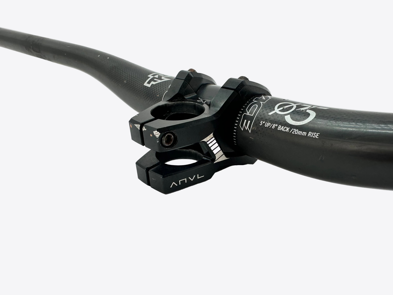Close-up of a black bike handlebar with ANVL branding on a light gray background