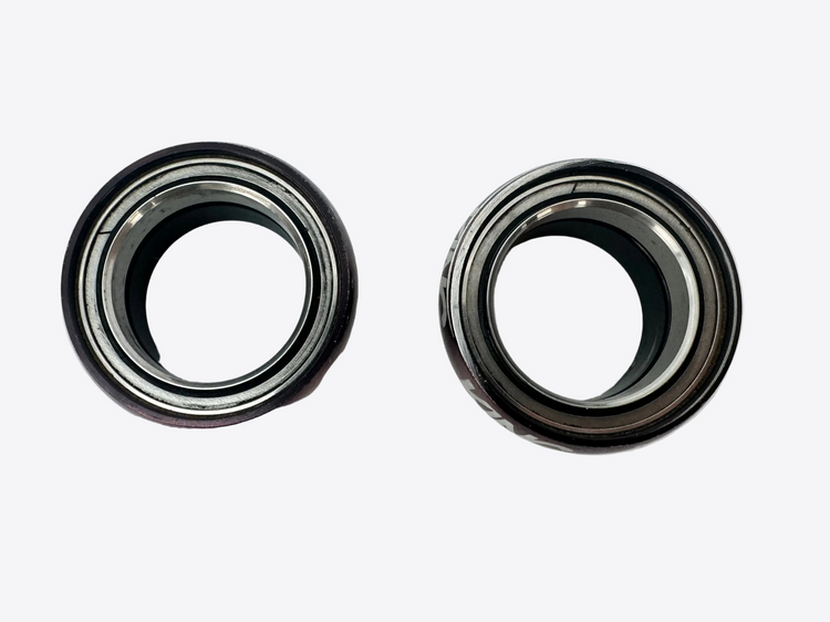 Two metal bearings on a white surface