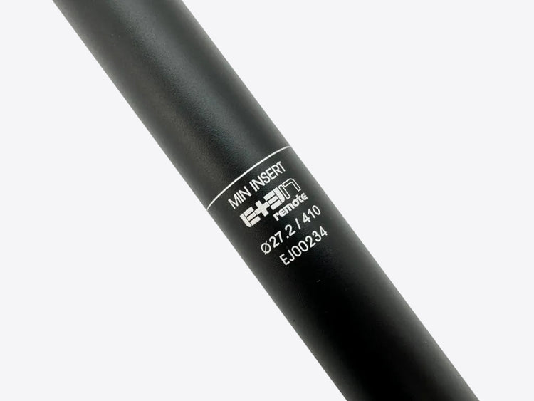 Black cylindrical object with a label on a light gray background