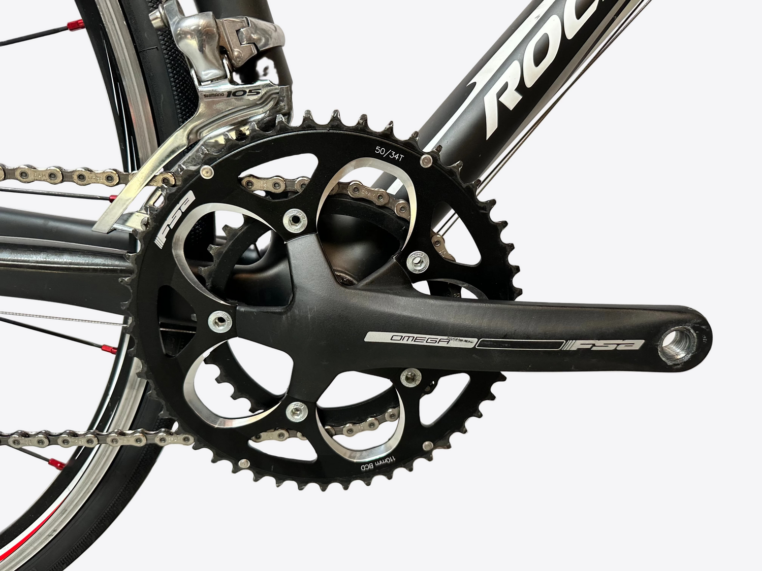 Close-up of a bicycle crankset with 'Omega' branding on a white background