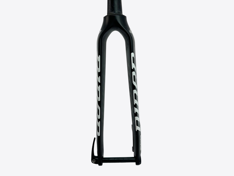 Black bicycle fork with white branding on a light gray background