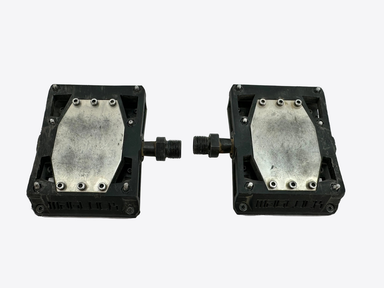 Two metallic square components with bolts on a white background