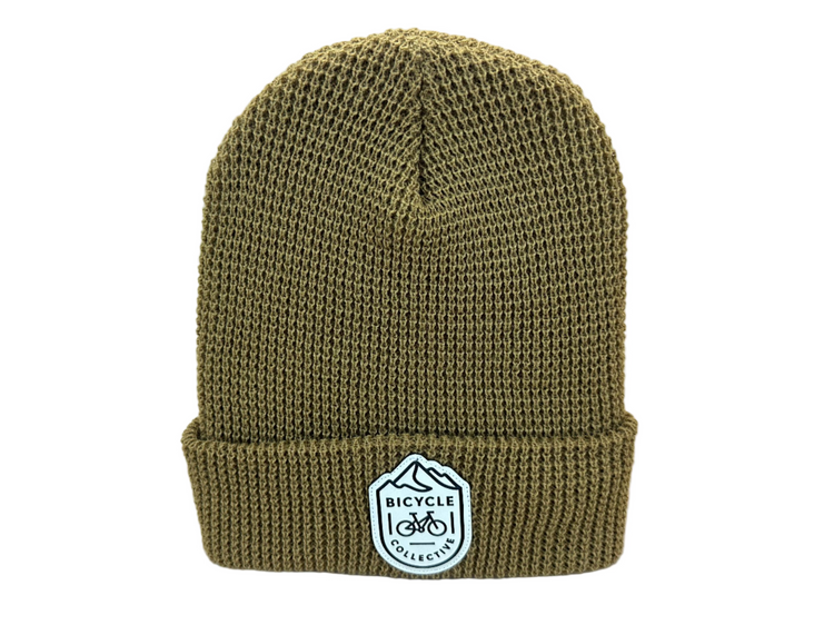 Brown Knitted beanie with a logo on a white background