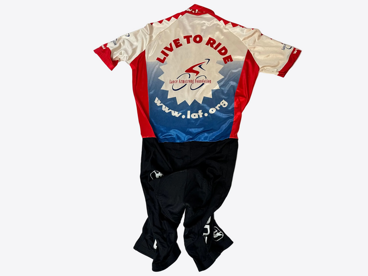 Cycling jersey and shorts with visible branding on a light gray background