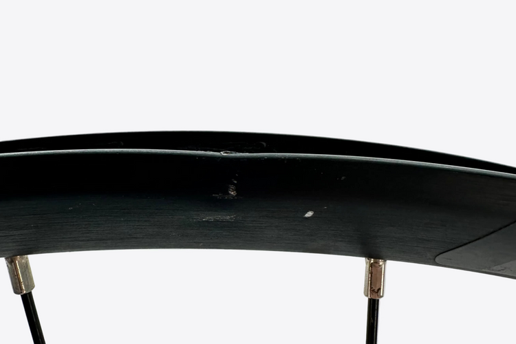 Close-up of a bicycle wheel with a white background