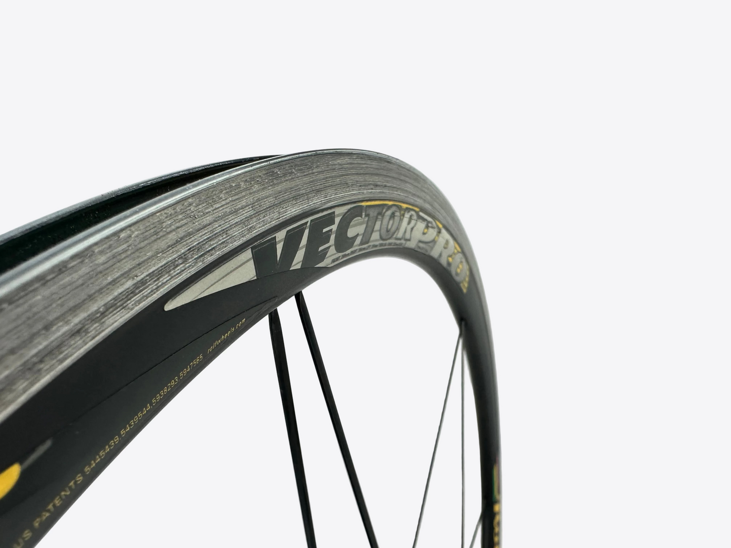 Close-up of a bicycle wheel with 'Vector' branding on a white background