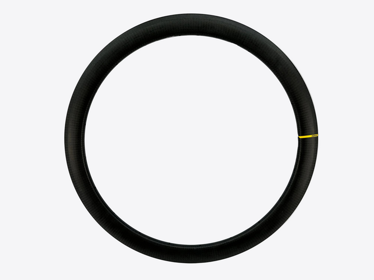 A black carbon fiber bicycle wheel rim shown against a plain white background, featuring a small yellow marking on the right side.