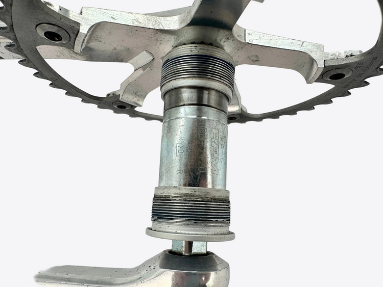 Close-up of a bicycle crankset on a white background