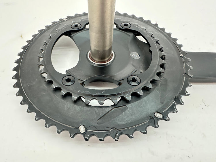 Close-up of a bicycle crankset on a white background