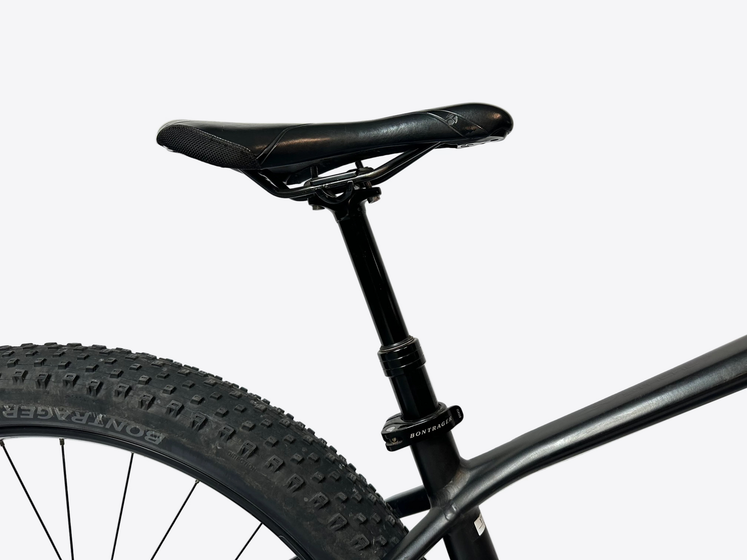 Close-up of a bicycle seat and frame against a white background