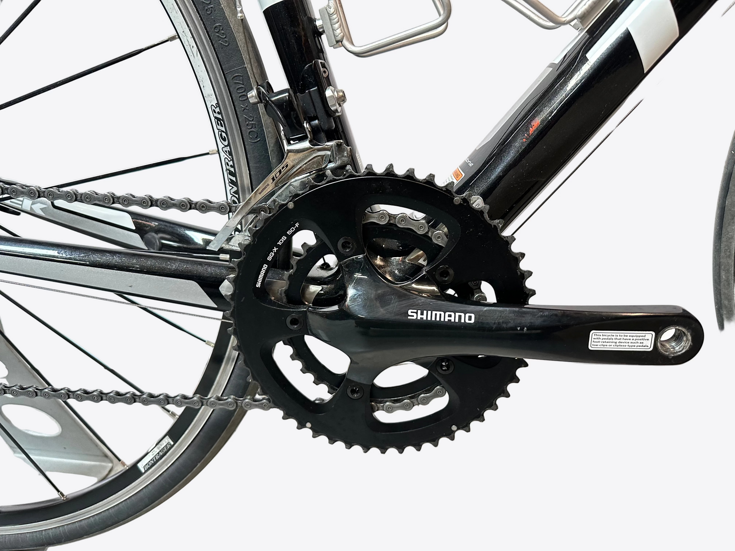 Close-up of a bicycle chain and gear system with Shimano branding.
