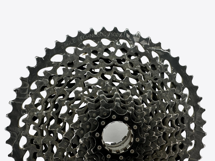 Close-up of a bicycle gear cassette on a white background