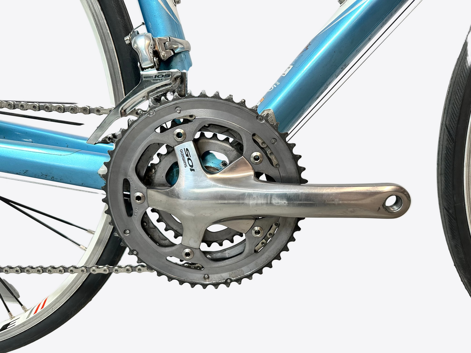 Close-up of a bicycle's chainring and chain on a white background