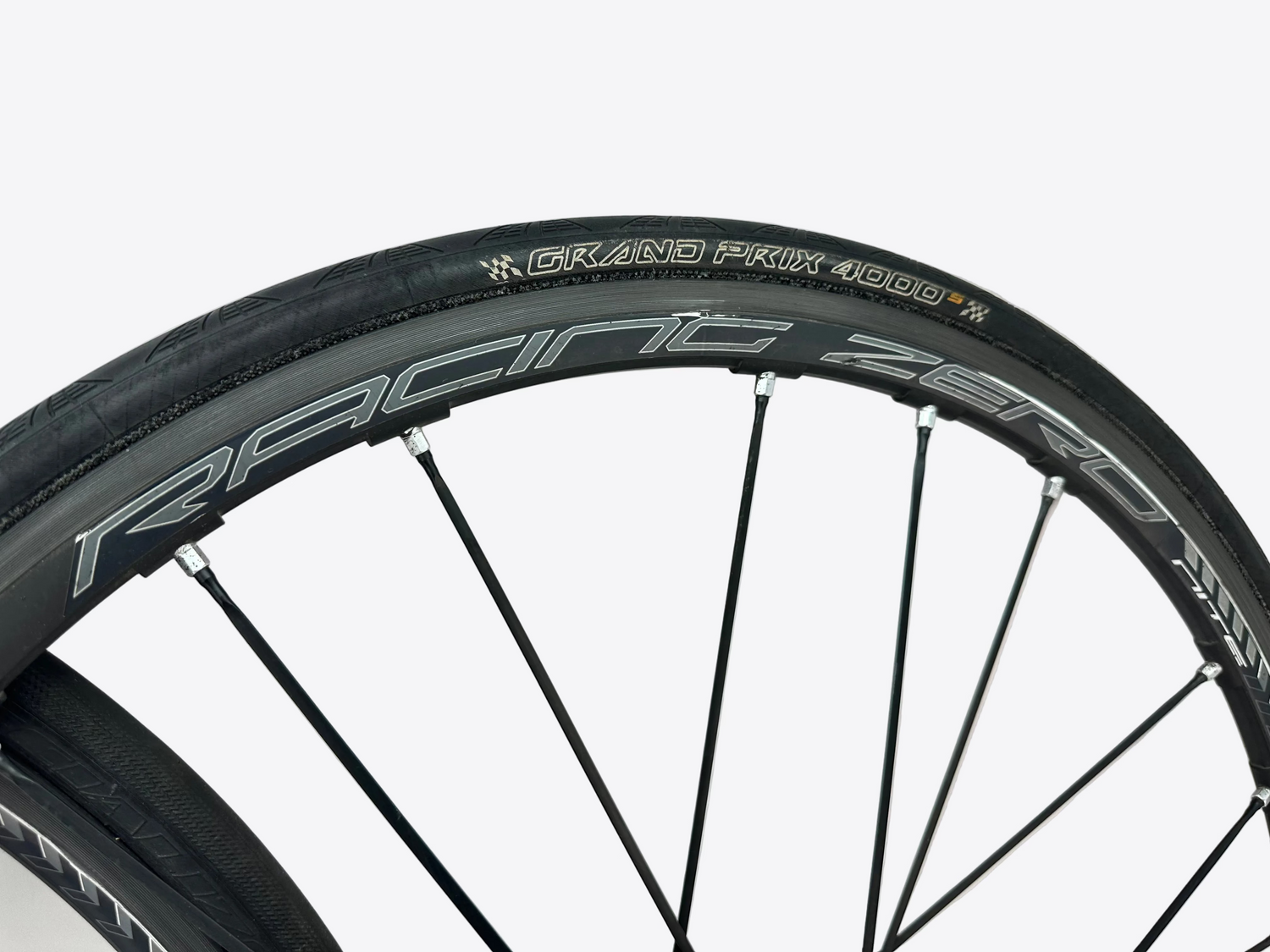 Close-up of a bicycle wheel with 'Racing Zero' branding on a white background