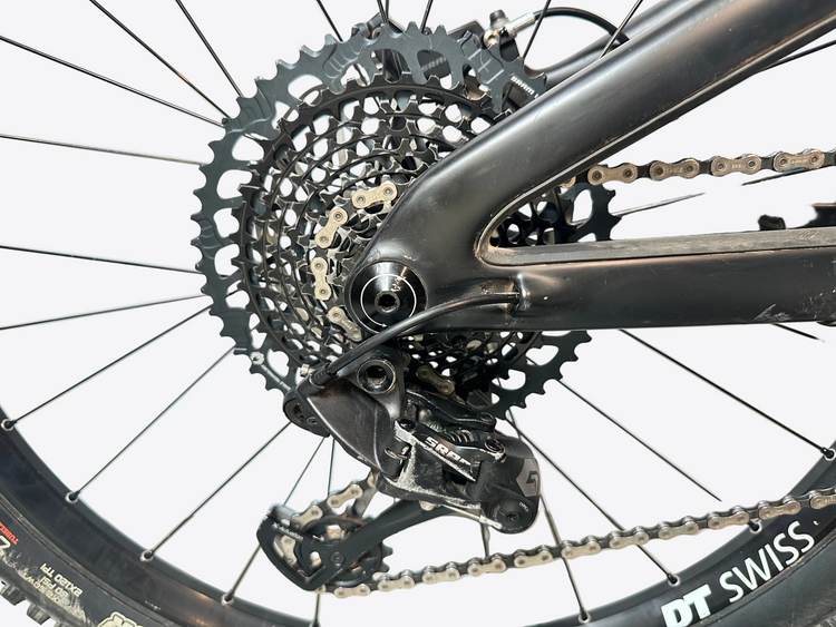 Close-up of a bicycle's gear system with 'DT Swiss' branding.