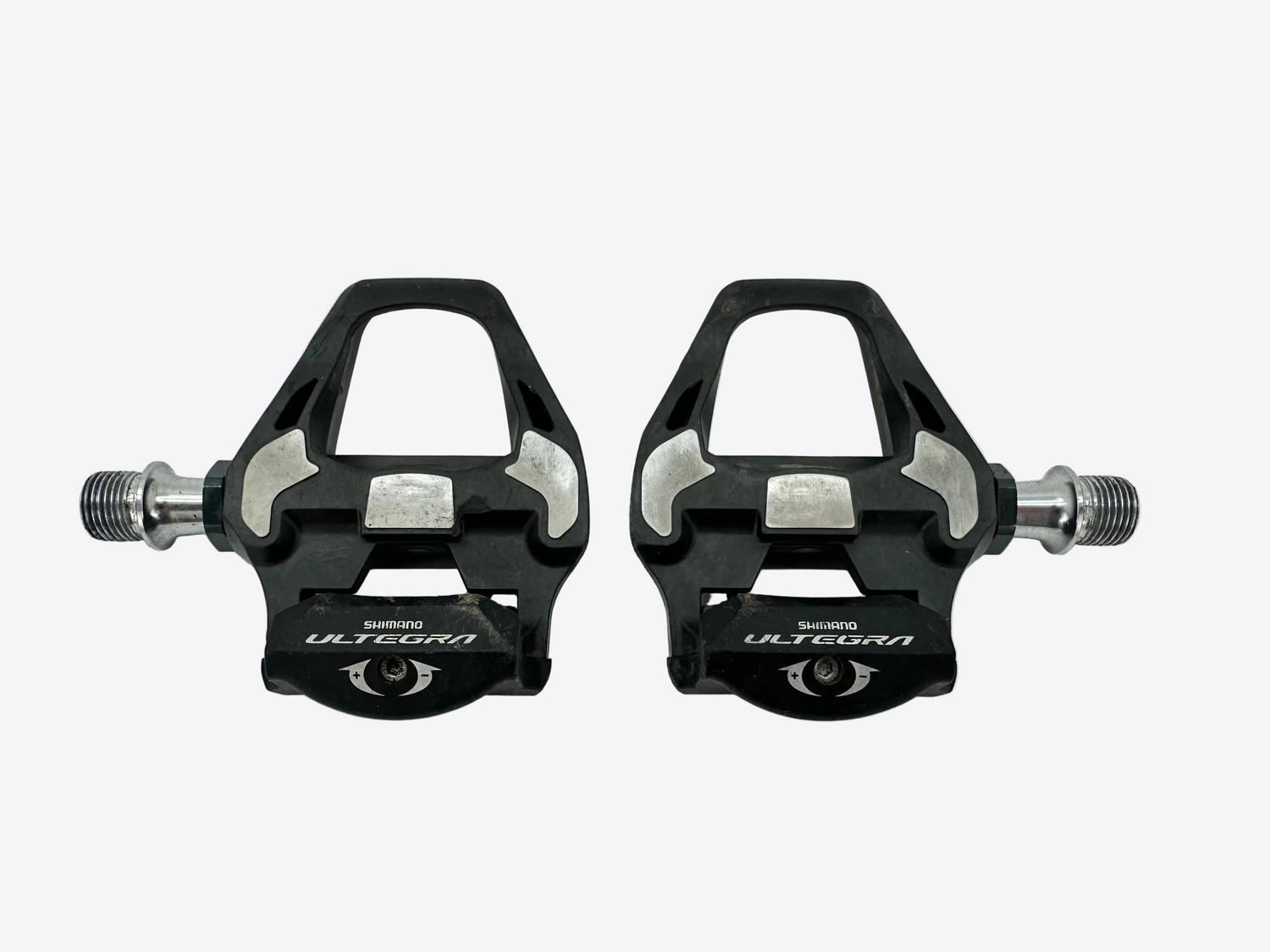 Pair of black Shimano Ultegra bicycle pedals on a white background