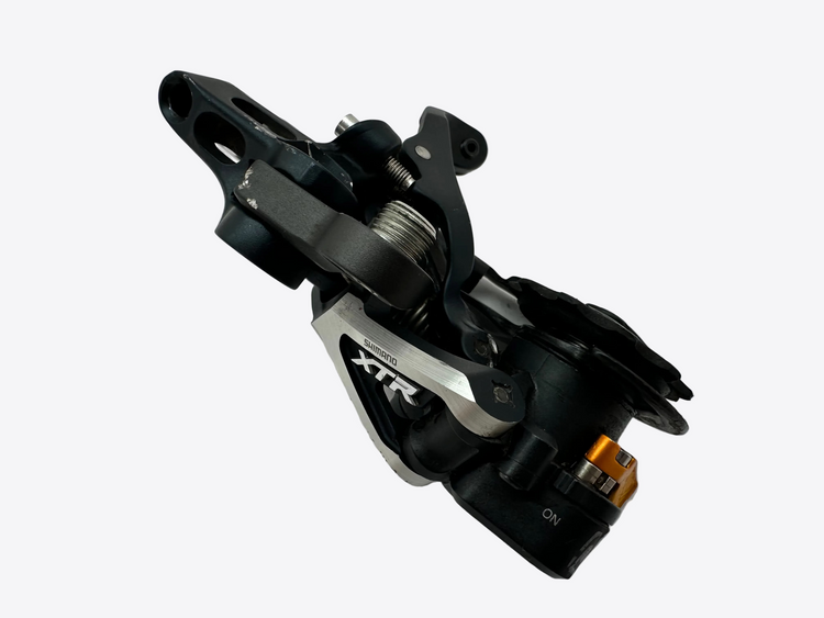 Bicycle derailleur with 'XTR' branding on a white background