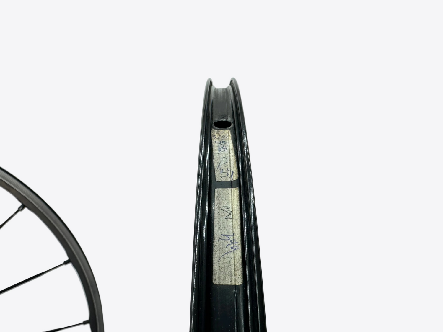 Close-up of a bicycle rim with brand name on a white background