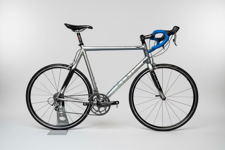 Silver bicycle with black tires on a white background