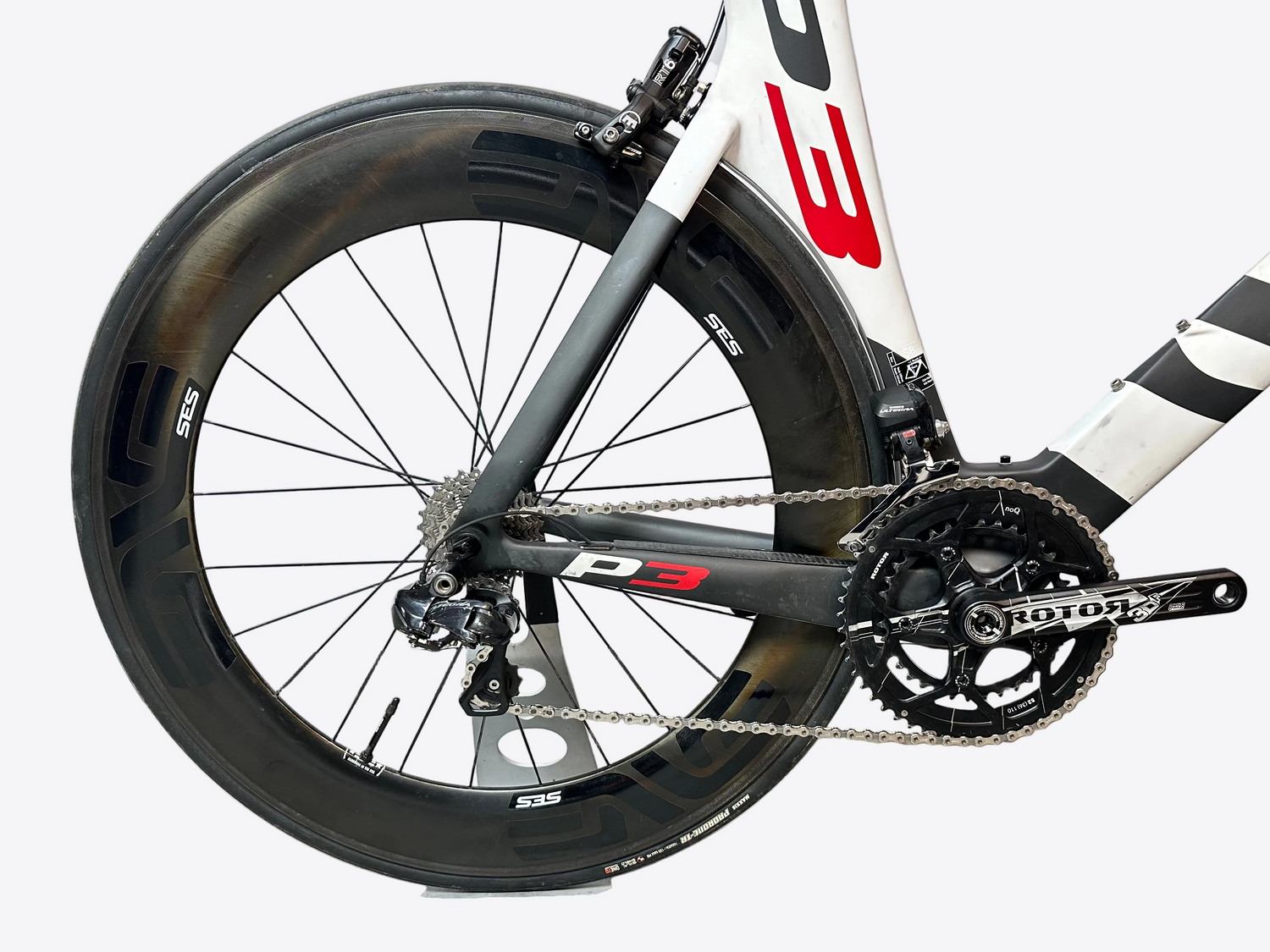 Close-up of a bicycle wheel and chainset with 'P3' branding on a white background