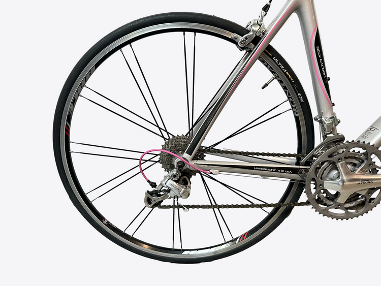 Close-up of a bicycle wheel and chain on a white background