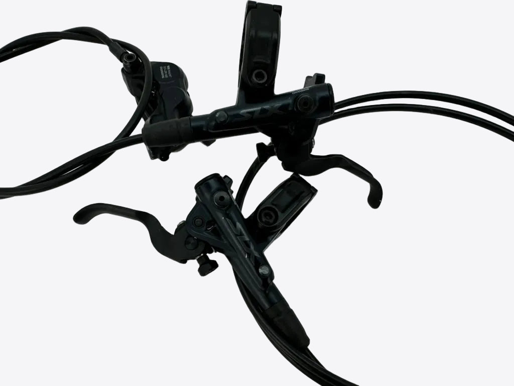 Black bicycle brake lever set with attached cables on a white background.