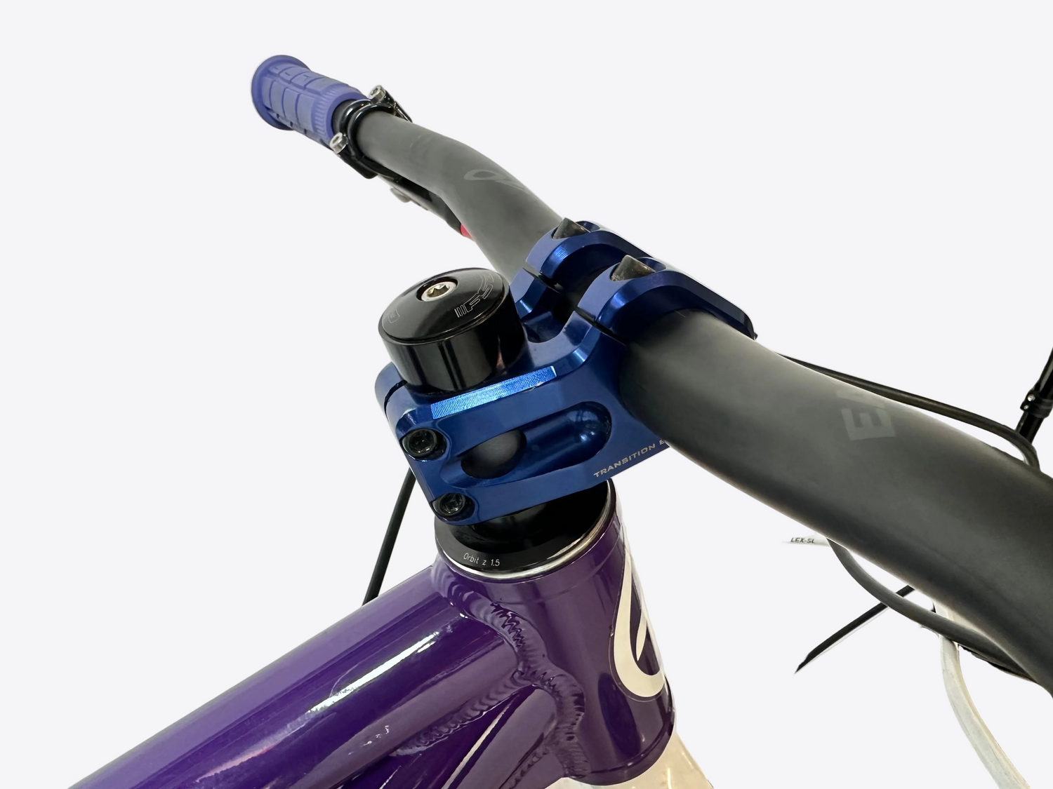 Close-up of a bicycle handlebar with purple and blue components on a white background