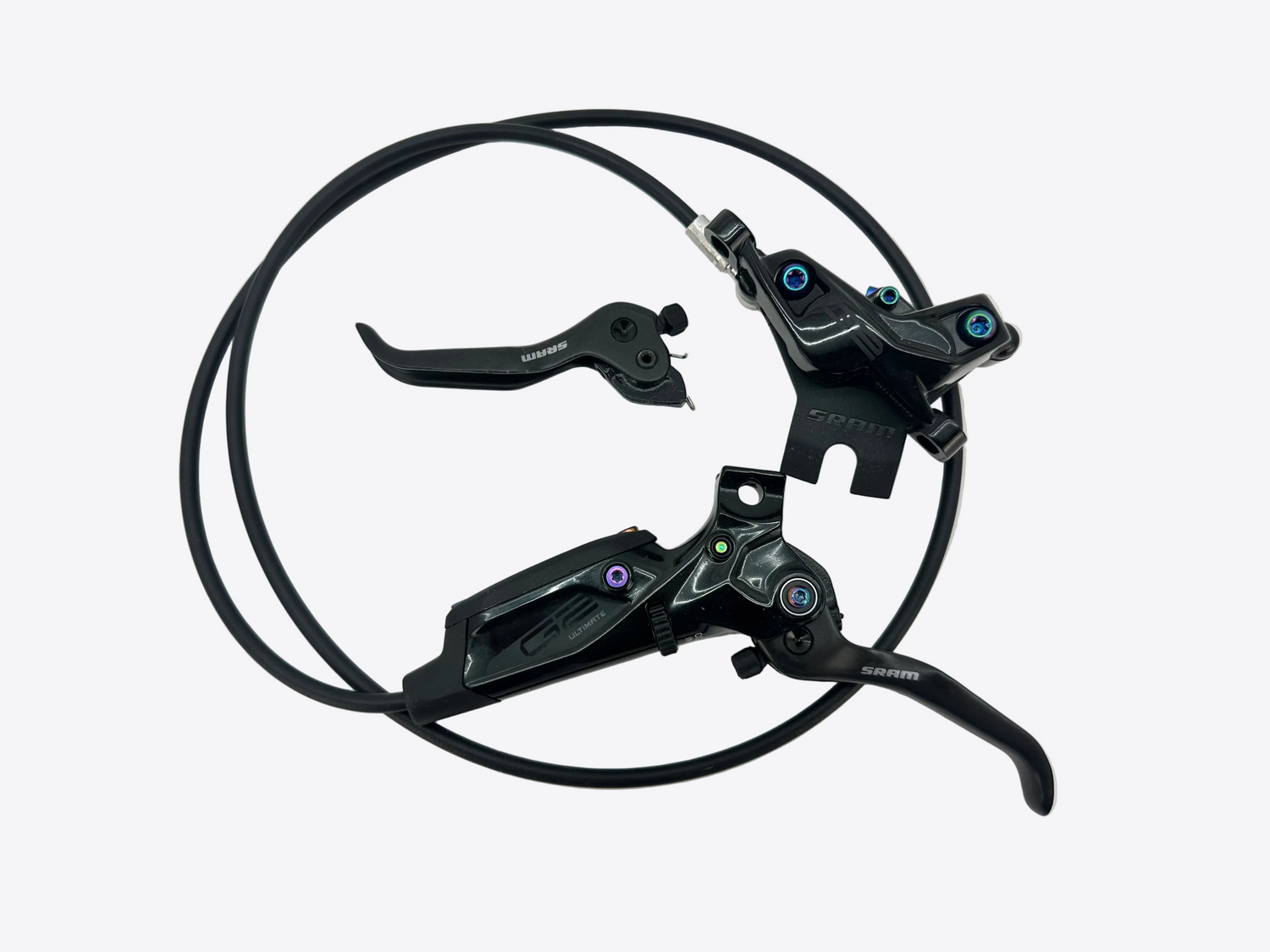 A pair of black bicycle disc brake levers with attached cables, photographed on a plain white background.
