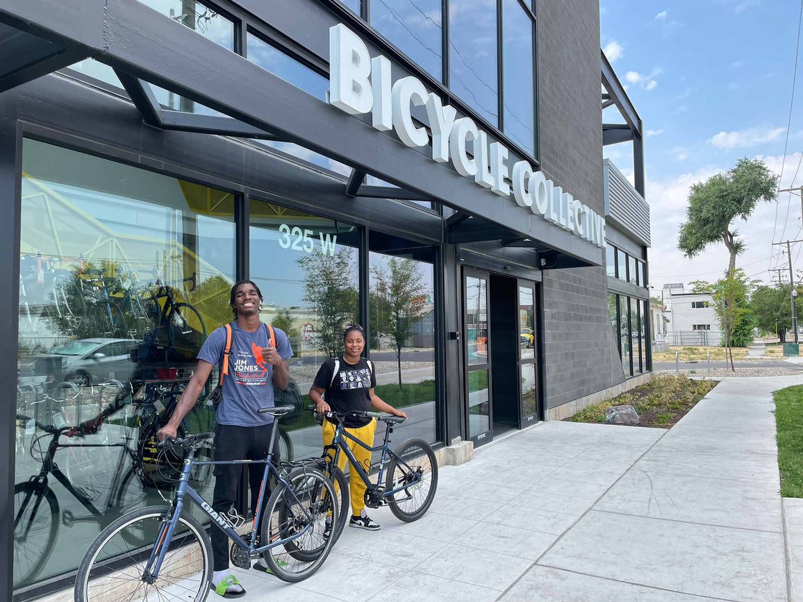 Two Bikes-For-Goodwill recipients with their new bicycles which they received for free, outside Bicycle Collective's Salt Lake City locaton.